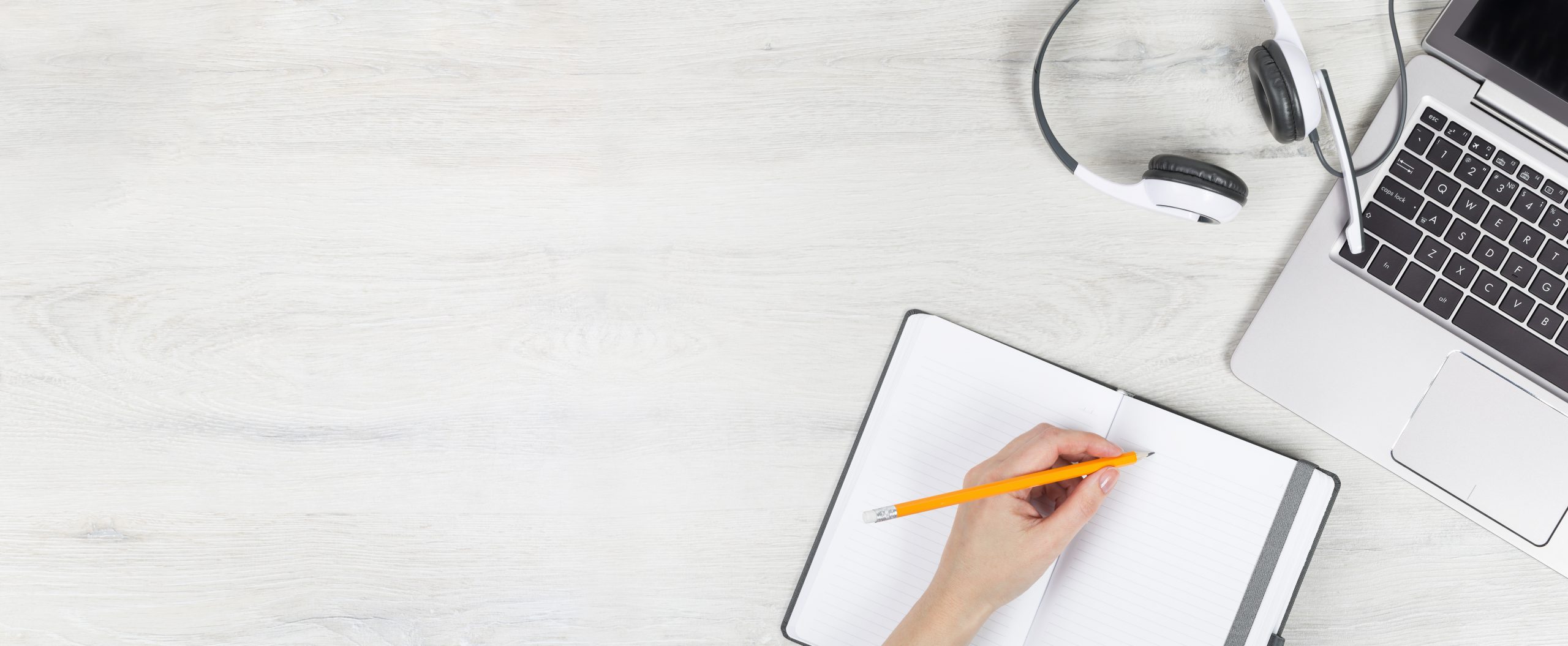 Laptop with headphones on white desk